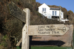 A sign pointing the way to Mousehole on the Cornish Coast. The Coast Path is popular walking, hiking route along the coast of Cornwall, England. (Photograph by Kim Newton)