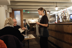 A waitress takes orders from customers at the Tolcarne Inn, Newlyn Harbour, Cornwall, England. (Photograph by Kim Newton)