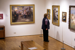 A visitor to the Penlee House Gallery and Museum in Newlyn, Cornwall, England,  examins a painting on display. Penlee House is home to many of the paintings by Newlyn School painters. (Photograph by Kim Newton)