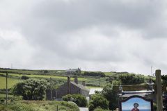 A couple walk their dogs on the road approaching the Tinners Arms pub in Zennor, Cornwall, England. The Tinners Arms was a favorite of British spy novelist David Cornwell. (Photograph by Kim Newton)