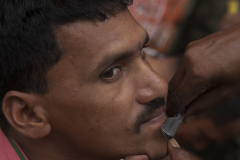 A street barber prepairs to shave a customer in Varanasi, India.