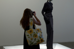 A student take a photograph of an art exhibit at the 2011