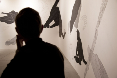 A silhouette of a man looking at an exhibit of the Biennalle di Venezia
