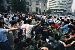 South Korean student protestors capture a group of government riot police during protests in downtown Seoul, South Korea. After months of violent protests, the student demands for constitutional reform, direct presidential elections, the release of political prisoners and the rights of dissidents to participate in the democratic process were granted by the ruling government on July 1, 987. (Photograph by Kim Newton)
