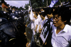Student protestors hold a picture of Yonsei University student, Lee Han Yol, 21, during anti-government protests outside his University in Seoul, South Korea. Lee died of head injuries inflicted June 9, 1987 after being hit by shrapnel from a tear-gas canister. (Photograph by Kim Newton)