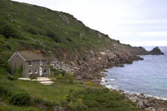 A stone house on the coast at the end of the bay in Lamorna Cove, Cornwell, England.