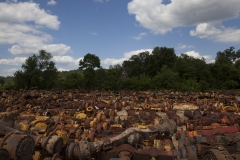 Old farm equipment sits in a junk yard in along the Mississippi River Delta on hwy 3 in Illinois.