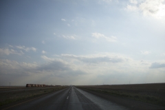 A freight train travels along the wide open stretches of state highway 60 between Amarillo, TX and Roswell, NM.