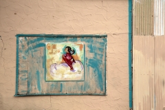 A framed mural of a native american woman on a wall in Elida, New Mexico.